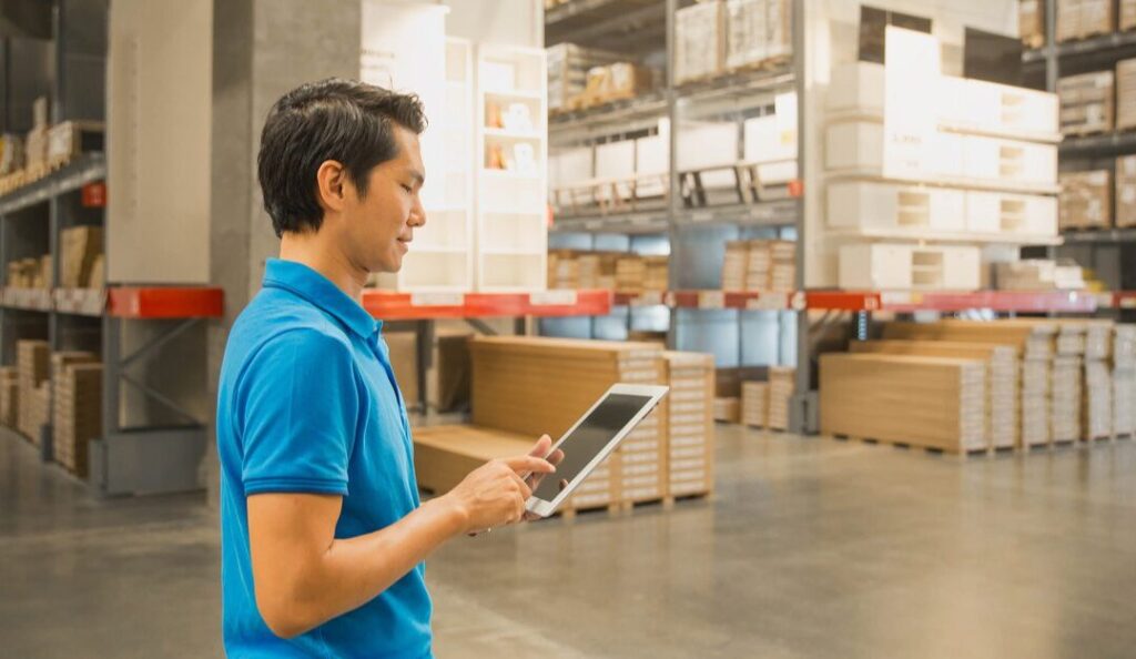 Man on tablet in warehouse