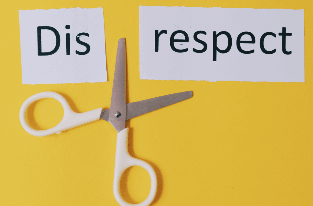 The word Disrespect cut into two words "dis" and "respect" with a pair of scissors