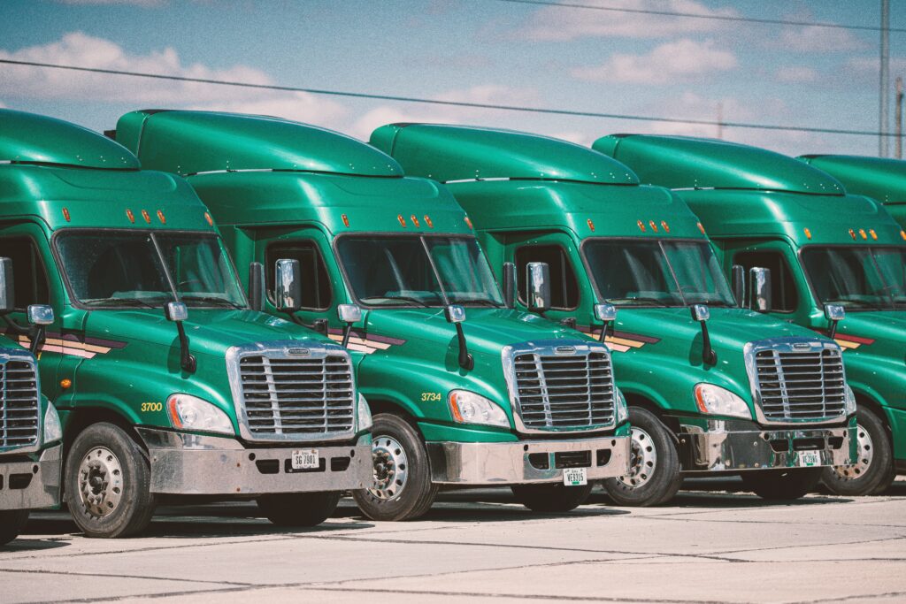 Green semi-trucks in a row